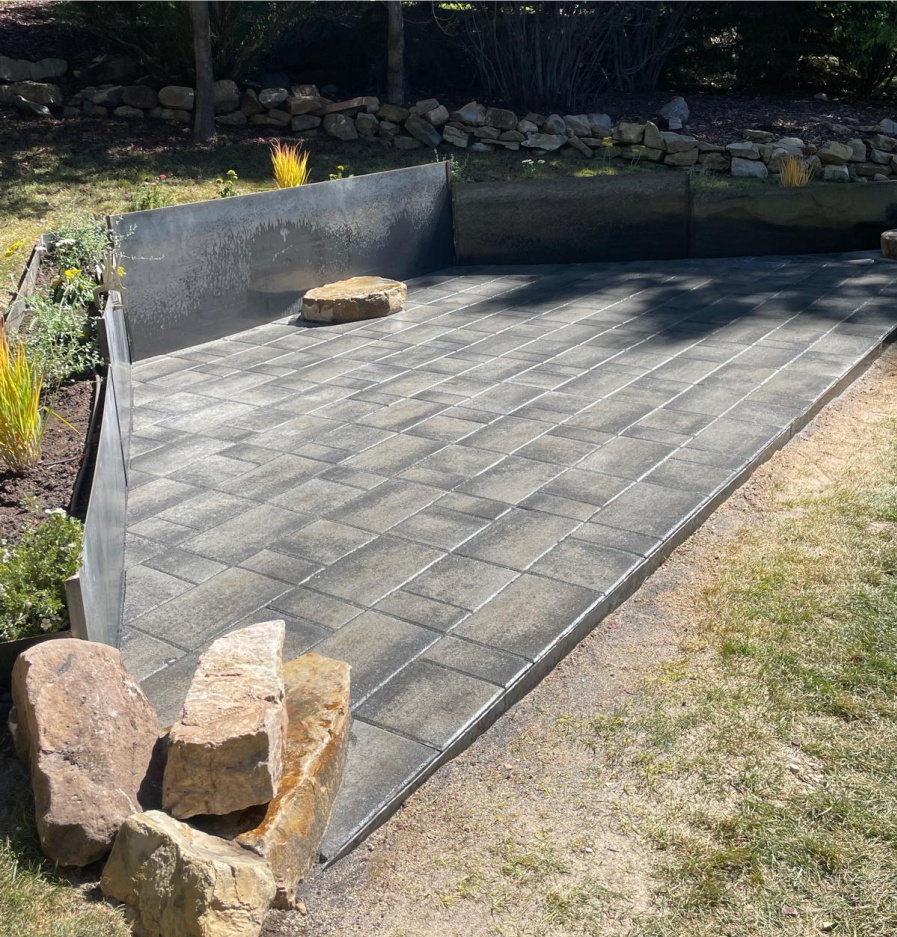 Backyard patio and retaining wall landscaping